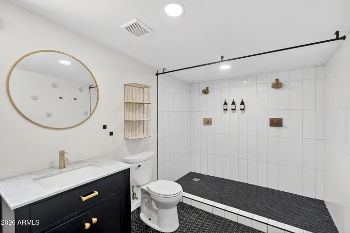 Primary suite bathroom, renovated, dual head walk in shower.