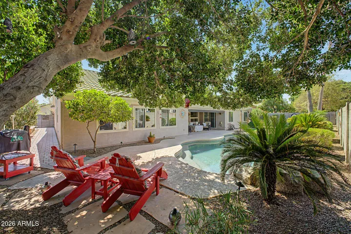 Relax Under Mature Trees Overlooking Your Backyard.