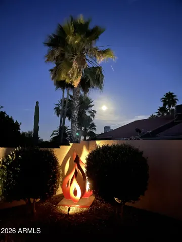 Lighted Yard Art with a moonrise.