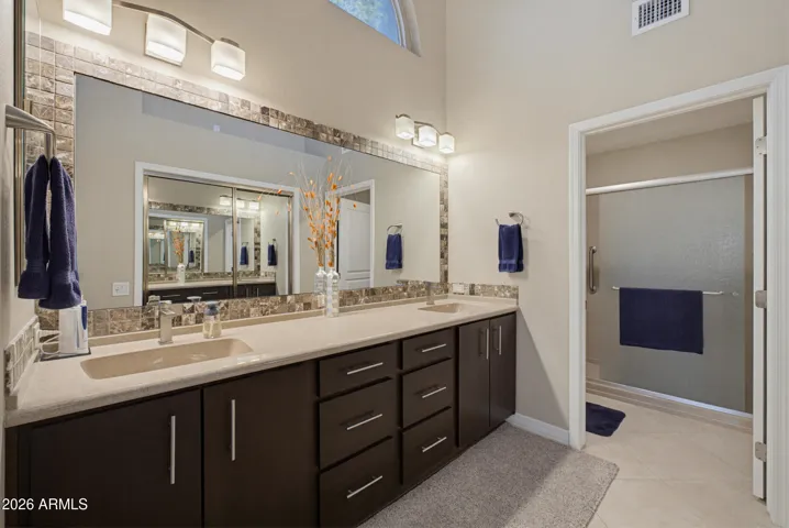 Counter-Height cultured marble countertops with integrated sinks.