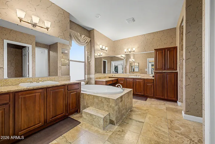 Very grand primary suite with double sinks, walk in shower & jetted tub