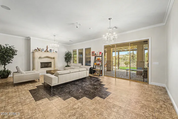 Expansive living room space, custom flooring, opens to large covered patio