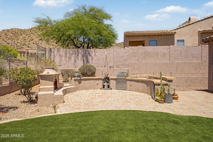 Outdoor living space with gas fireplace, grill, griddle & seating, exceptional for entertaining