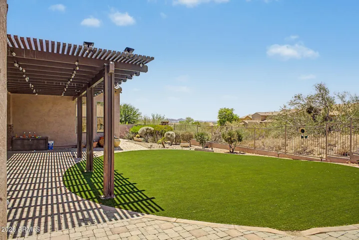 Low maintenance backyard with artificial grass & pavers