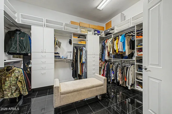 Expansive walk-in closet is thoughtfully designed to combine luxury, organization, and everyday functionality