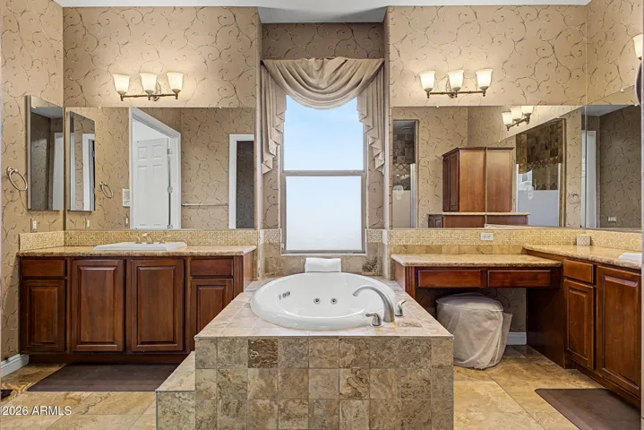 Spa-inspired bath features a luxurious soaking and jetted tub designed for ultimate relaxation