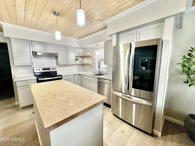 KITCHEN WITH NEW APPLIANCES AND BUTCHER BLOCK ISALND