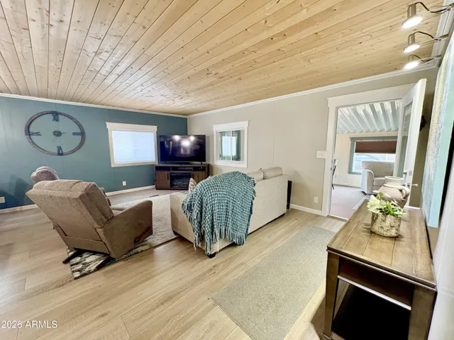 LIVING ROOM WITH LUXURY PLANK FLOORING AND FIREPLACE TV STAND