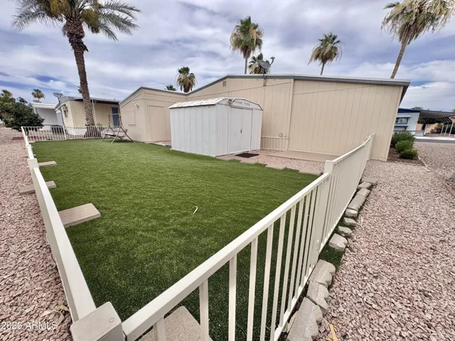 BACK YARD FENCED WITH SYNTHETIC GRASS