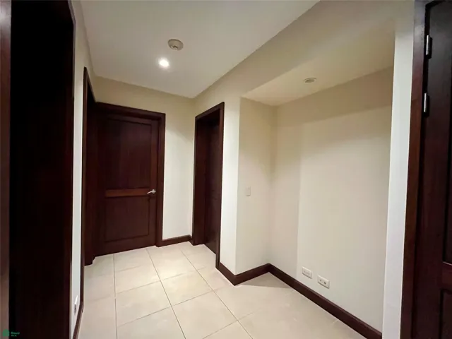 Lobby to the bedrooms with linen closet, desk space and split air conditioner.