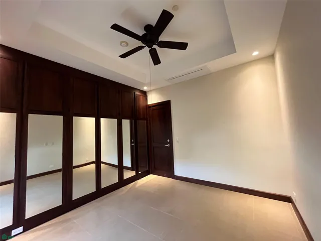 Third bedroom with split air conditioner, ceiling fan and mirrored aromatic cedar closet.