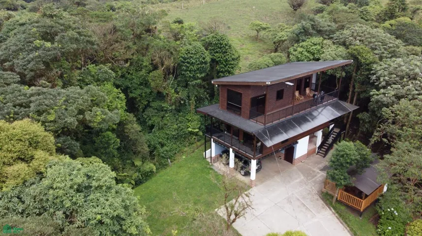 Second mountain-style cabin surrounded by lush forest, featuring spacious terraces, private parking, and peaceful natural surroundings ideal for relaxation or rental income potential.