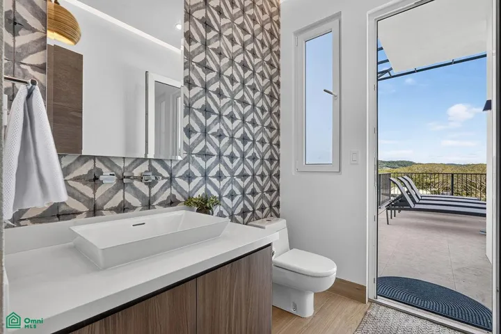 guest bathroom on main floor which can be entered from main living area or also from the pool deck