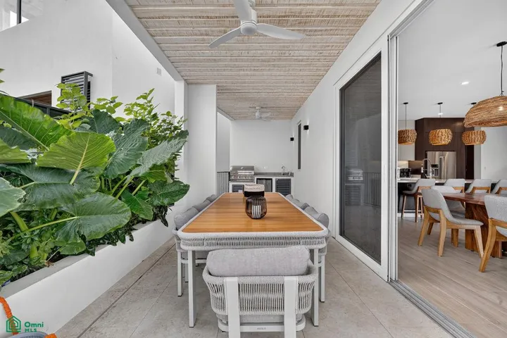 covered outdoor dining / bbq area on main terrace where pool is located