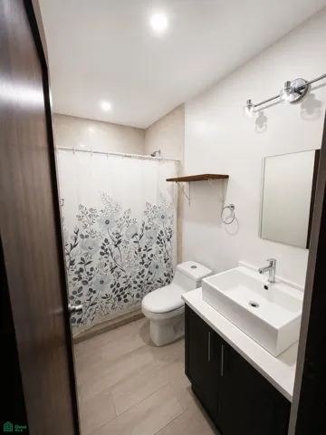 Full bathroom with a modern vanity and tiled walk-in shower.