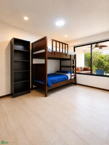 Second bedroom with bunk beds and a view toward the enclosed flex space.