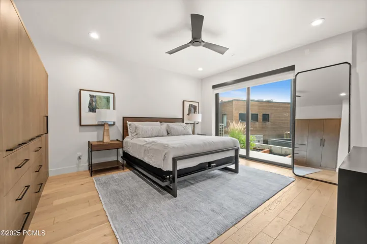 Downstairs, in the primary bedroom, sliding doors walk out to a quiet patio.