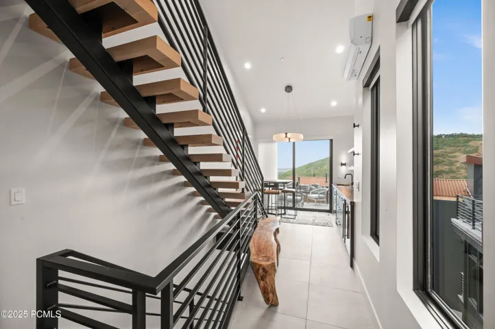 Upon entering the home, one is struck with the beauty of the hillside captured in the view.