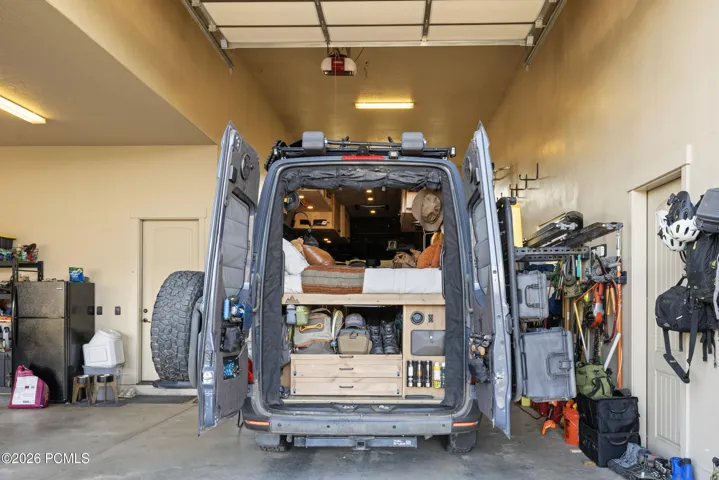 Sprinter van in front half of RV Garage