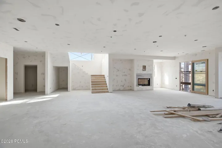 Lower level living room with 11 foot ceilings, gas fireplace and wet bar
