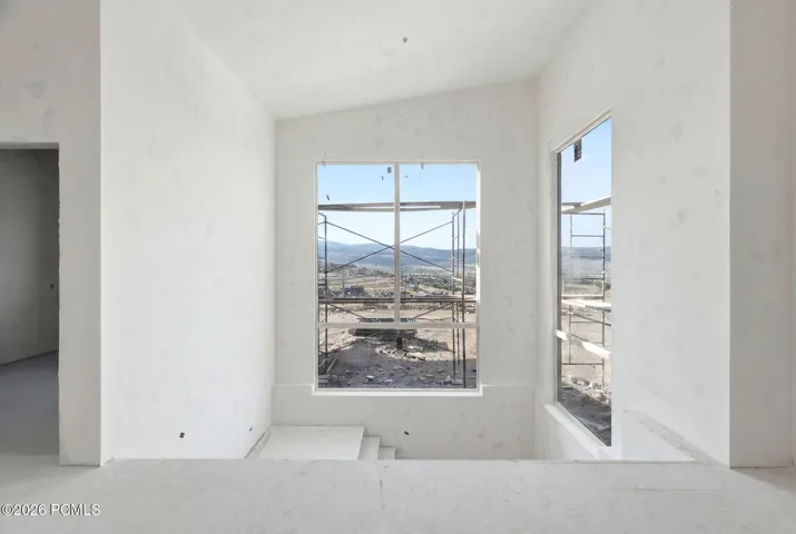 Main level staircase with oversized windows