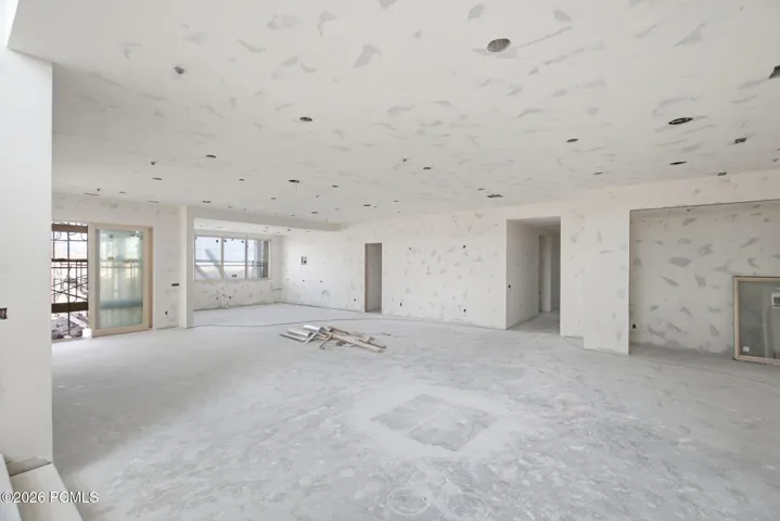 Lower level living room with 11 foot ceilings, gas fireplace and wet bar