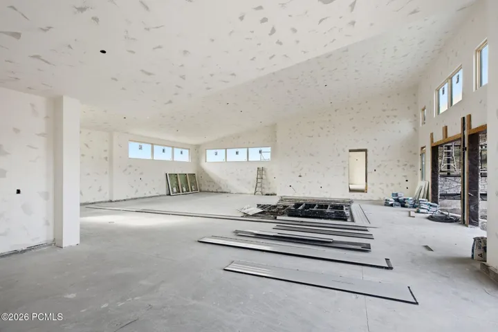 Oversized 7 car garage with two car chargers, speakers and ceilings high enough for car lifts