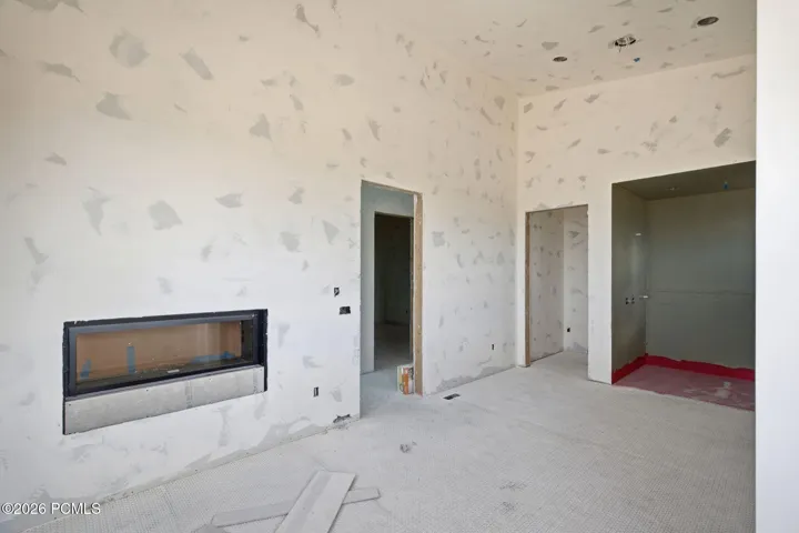 Primary suite bathroom with double sided fireplace, steam shower and free standing tub