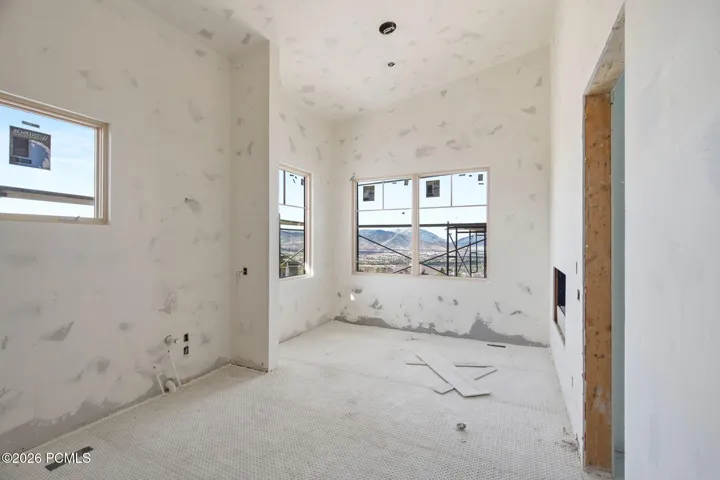 Primary suite bathroom with double sided fireplace, steam shower and free standing tub