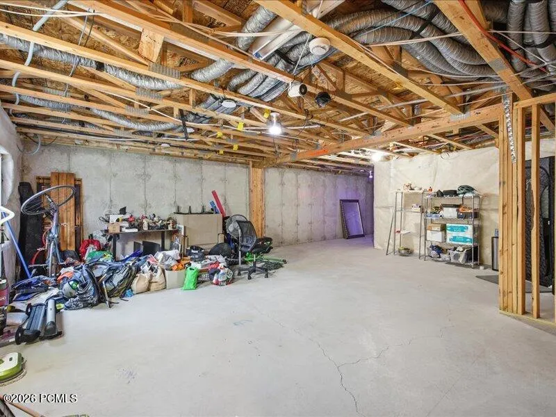 View of unfinished basement plumbed for bathroom