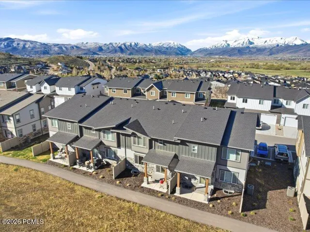 Aerial view of residential area featuring a mountainous background