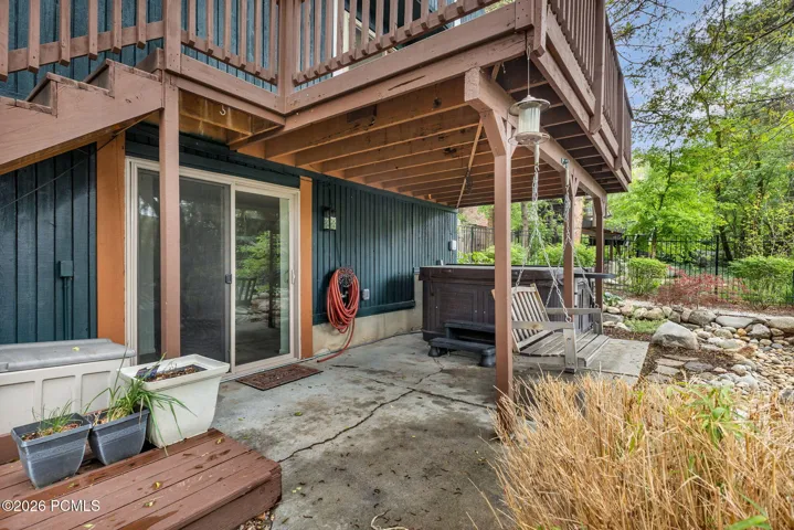 Patio outside of walkout basement and hot tub