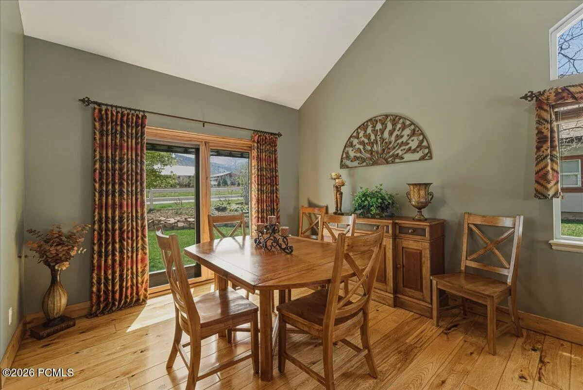 Dining Room with Vaulted Ceilings, Hickory Floors and Pella Sliding Glass Door.