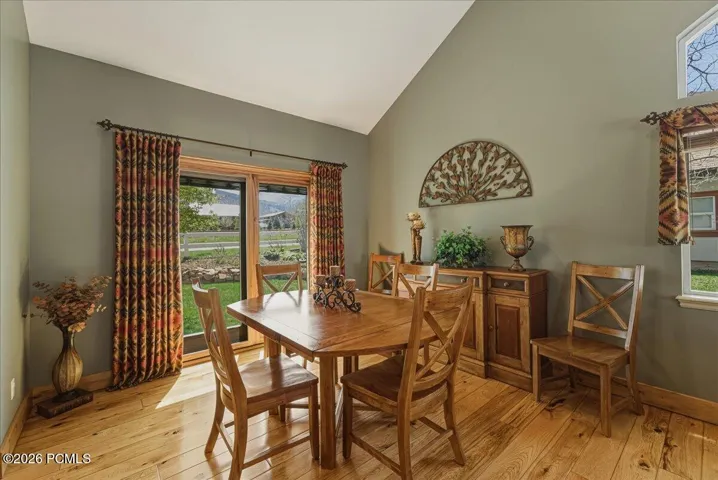 Dining Room with Vaulted Ceilings, Hickory Floors and Pella Sliding Glass Door.