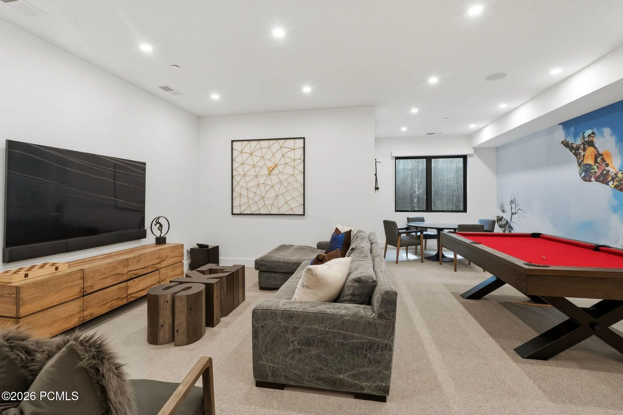 Spacious living room featuring recessed lighting, poker table, pool table, and TV area