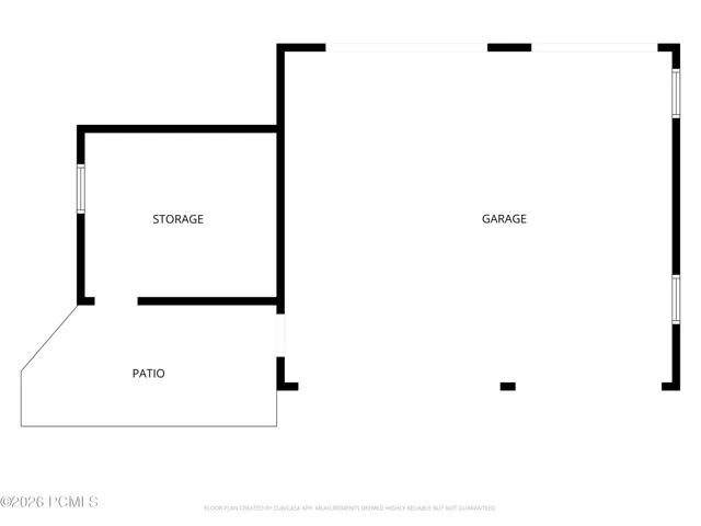 Large, detached garage featuring tandem drivethrough doors and a dedicated storage area.