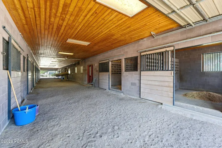 Main Breeding / Veterinary Barn, Attached/connected to the main home; includes indoor wash rack, stocks, phantom, breeding/veterinary lab, rubber mats, and indoor hot walker. 13 stalls, each approx. 15' x 14'