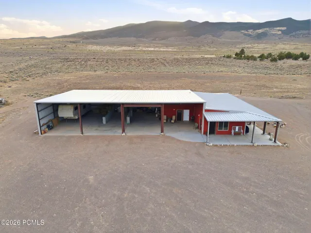 Approx. 6,000 sq ft total building footprint. Includes two living quarters: a 2-bed/1-bath apartment and a studio, plus RV storage, RV hookups & RV dump, septic tank, and equipment/storage space.