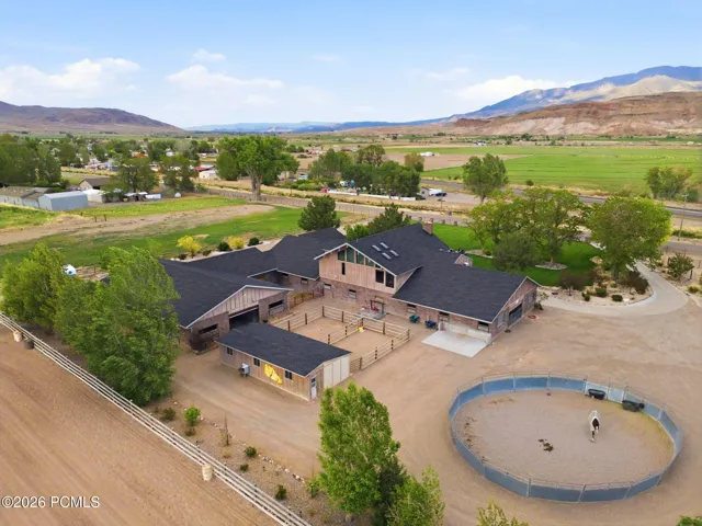 Main Residence, Main Breeding / Veterinary Barn, Stallion / Back Barn & Detached 2 Car Garage. One bay has double sided door for drive through access.