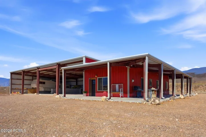 Detached ADU & Ranch Support Building 50' x 120' Approx. 6,000 sq ft total building footprint. Includes two living quarters: a 2-bed/1-bath apartment and a studio, plus RV storage, RV hookups & dump, septic tank, and equipment/storage space.