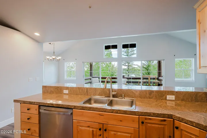 Kitchen looking into vaulted living room