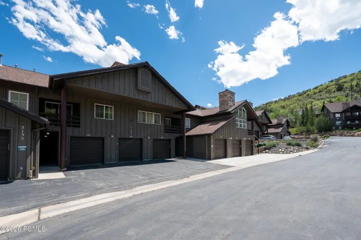 Exterior with garage and dedicated parking spot