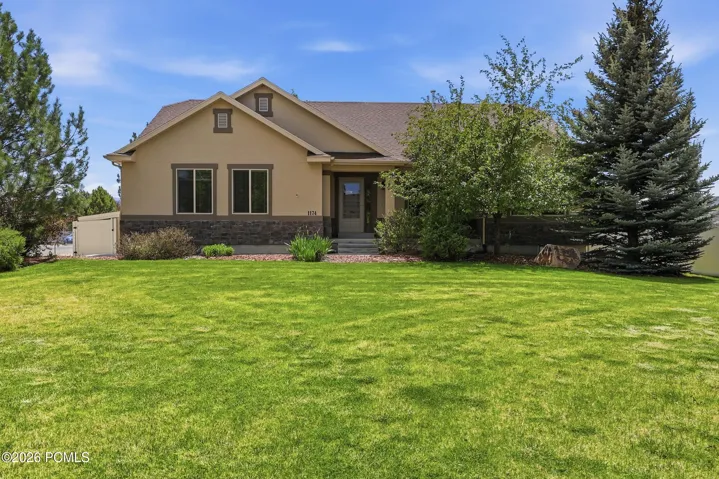Expansive front lawn with mature landscaping