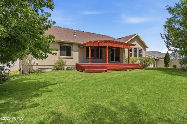 Beautifully landscaped private, fenced back yard with no back neighbors and a covered deck for BBQs, and relaxing.