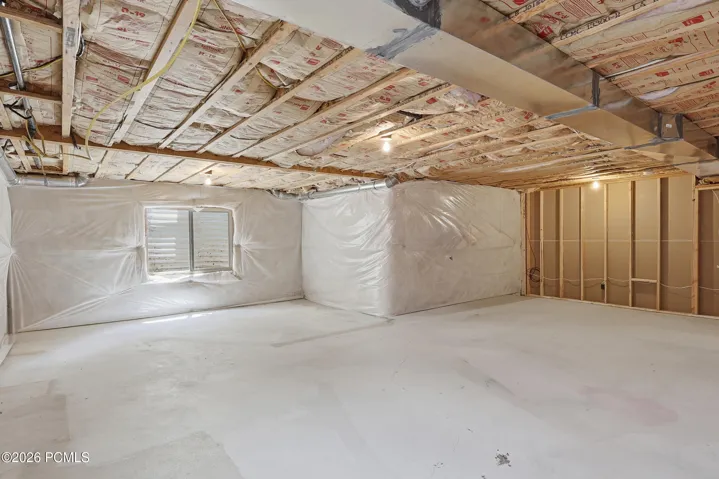 Unfinished basement featuring insulation on walls and between levels in the ceiling. Room for a large family room and another bedroom.