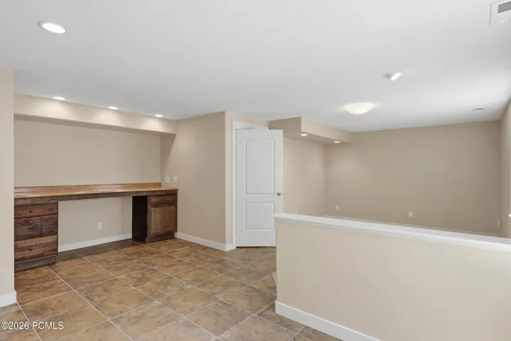 A large room used as a recreation room with a bar. It could be two bedrooms if desired.