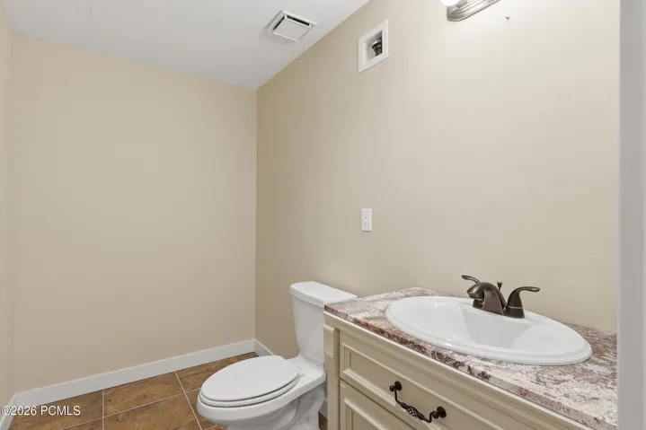 Bathroom #3 featuring a vanity with a white oval sink, dark bronze-finish faucet, and a space roughed in for a walk-in show or a tub/shower combo.