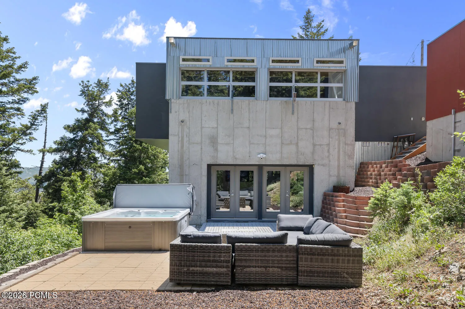 Back patio with hot tub and upper porch area