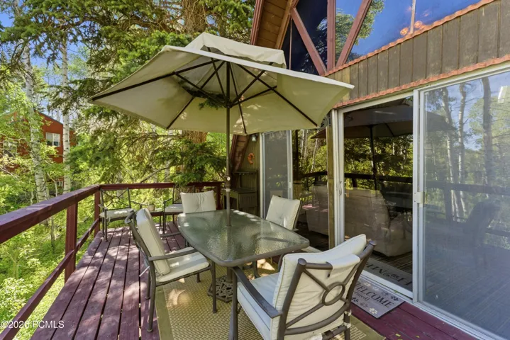 The elevated deck provides an ideal outdoor living space with room for dining and gathering, all surrounded by towering pines and the privacy of a heavily wooded 1.03-acre lot. A perfect place to enjoy mountain mornings, evening sunsets, and year-round cabin living.