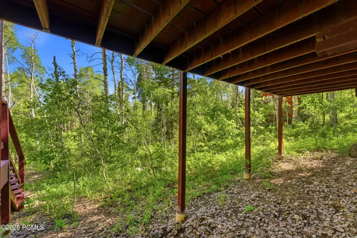 Under-deck area with wooded yard view and natural surroundings in Timberlake, Utah